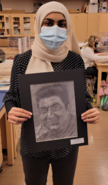 Minal Naeem holding her completed hero portrait.