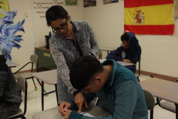 Mrs. Gonzalez helping a student with their classwork